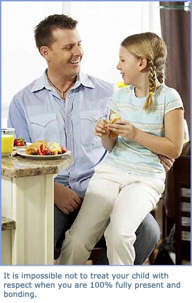 Happy girl sitting on her fathers lap during breakfast. Dad is looking into her eyes and smiling.