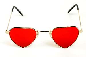 Unconditional parenting: Sunglasses with read heart shaped glass.